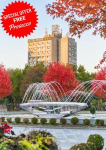 a fountain in a park with a building in the background at Hotel Cetate in Alba Iulia