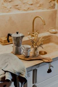 a kitchen counter with a coffee pot and a cup at 16Th Century Farmhouse Between The Tuscan Hills in Brancorsi