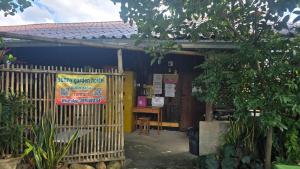 a building with a fence in front of it at Sunny hostel in Pai
