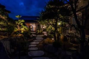 a walkway in front of a house at night at 蒼々さぬき志度 SOUSOU Sanuki Shido in Sanuki