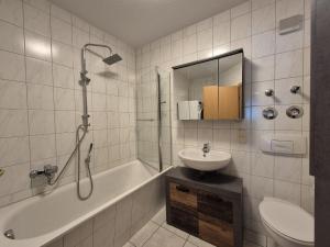 a bathroom with a sink and a toilet and a shower at Mikra Homes24 in Glauchau in Glauchau
