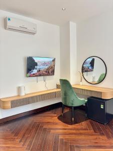 a waiting room with a chair and a mirror at MAIA Hotel & Apartment Danang in Da Nang