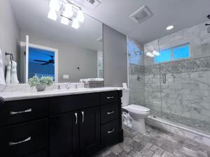 a bathroom with a sink and a toilet and a shower at Destination #33 in Orange +32 photos