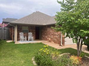 a brick house with two chairs on a patio at Paradise on the Prairie in Oklahoma City