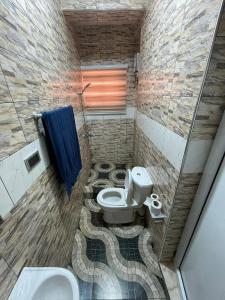 a bathroom with a toilet and a sink at 2 Chambres Élégantes Confort Moderne in Santeo +17 photos