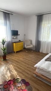 a bedroom with a bed and a desk and a chair at Bachner Rental Fagaras in Făgăraş