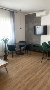 a living room with a table and chairs at Bachner Rental Fagaras in Făgăraş +3 photos