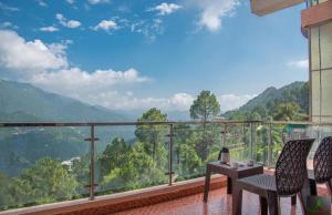 a balcony with a view of the mountains at The Western Heights I Serviced Apartments I Pvt Balcony I Peacefull Area I Family Accomodation I Kasauli By Exotic Stays in Kasauli