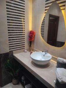 une salle de bain avec un lavabo et un miroir dans l'établissement Villa luxueuse, à El Guern