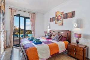 a bedroom with a bed and a view of a pool at Villa Tania in Playa Blanca +23 photos