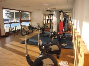 a gym with treadmills and exercise bikes in it at Le Manchot - Au pied des remontées mécaniques in Chamrousse