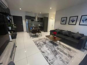 a living room with a couch and a table at Embassy Onebedroom by Unique Abodes in Accra +20 photos