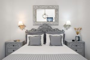 a bedroom with a bed with a mirror and two night stands at Geronti Moscha Apartment in Apollonia
