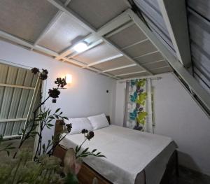 a small room with a bed and a window at Tree Nature Resort in Hali Ela