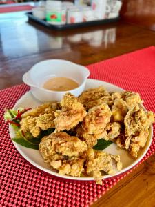 a plate of fried food with a bowl of dipping sauce at Komodo Top Sailing in Labuan Bajo