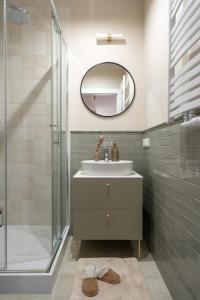 a bathroom with a sink and a mirror at Red Roof Apartments Old Town in Kraków +12 photos
