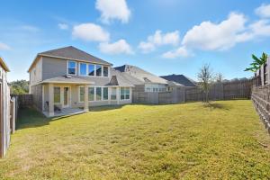 a home with a fence and a yard at Gorgeous Lake Conroe Home, Affordable Nightly Rent in Keenan
