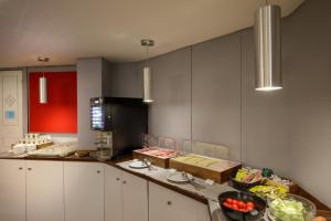 a kitchen with a counter with food on it at Hotel Oxford in Rome