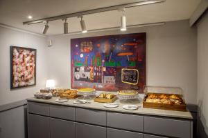 a buffet with bread and pastries on a counter at Hotel Oxford in Rome