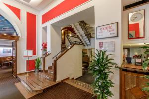 a lobby with a staircase in a building at Hotel Oxford in Rome