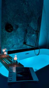 Dimora in Cortile في مانفريدونيا: حمام مع حوض استحمام وطاولة ومصباح