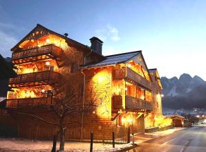 a large brick building with lights on it at SEIN Boutique Suites - ADULTS ONLY in Gosau