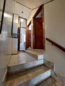 a hallway of a house with stairs and a refrigerator at La casa nel borgo - le comodità di una intera casa vicina a tutti i servizi in Porto San Giorgio