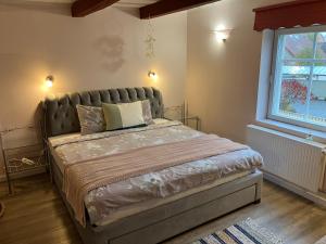 a bed in a bedroom with a large window at City View Loft in Viljandi