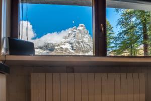 a view of a mountain from a window at MCX Vacation Rental- Cervino Lodge in Breuil-Cervinia