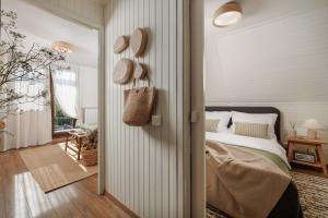 a bedroom with a bed and a door leading to a hallway at Hillside Lodge, Boutique & Spa in Lič