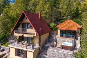 an aerial view of a house with a red roof at Hillside Lodge, Boutique & Spa in Lič