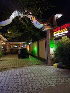 a car parked in front of a building at night at Kasai in Dodoma