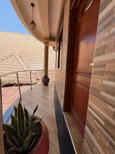 a porch with a door and a potted plant at Kasai in Dodoma