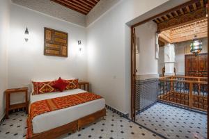 a bedroom with a bed and a balcony at Riad Dar Sira in Fès