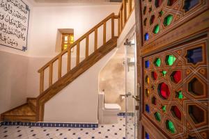 a bathroom with a staircase and a door with stained glass at Riad Dar Sira in Fès +49 photos