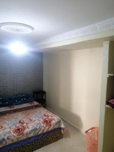 a bedroom with a bed and a light on the ceiling at Dar Sofiane in Sidi Bouzid