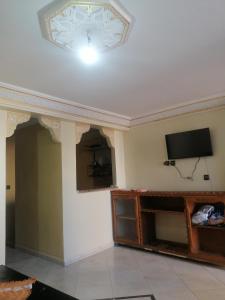 a living room with a flat screen tv on a ceiling at Dar Sofiane in Sidi Bouzid