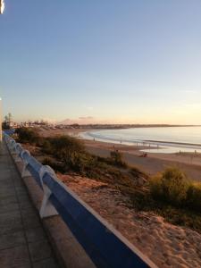 a view of a beach with a fence and the ocean at Dar Sofiane in Sidi Bouzid