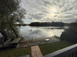 a view of a lake with a bench on a dock at King Carp in Tattershall
