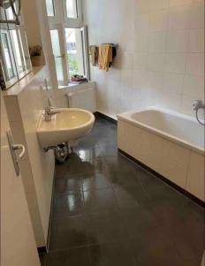 a bathroom with a sink and a bath tub at Cozy room with private balcony, center berlin in Berlin