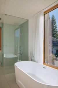 a white bath tub in a bathroom with a window at Haus Aerli in Ehrwald +87 photos