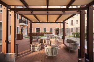 an outdoor patio with furniture and tables and chairs at Palazzo dei Guardiani in Venice +21 photos