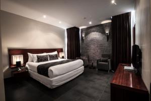 Ένα ή περισσότερα κρεβάτια σε δωμάτιο στο Lamana Hotel