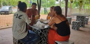 a group of people sitting at a table at Yala Thaman in Kataragama