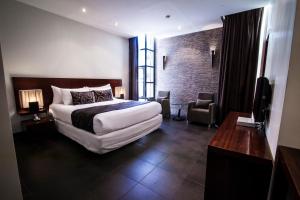 Ένα ή περισσότερα κρεβάτια σε δωμάτιο στο Lamana Hotel
