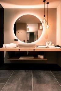 a bathroom with a sink and a mirror at Belia Lofts - ADULTS ONLY - Apartments in Appiano sulla Strada del Vino