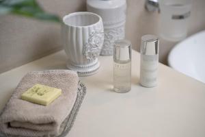 a bathroom counter with a bottle of soap and towels at Geronti Moscha Apartment in Apollonia +140 photos