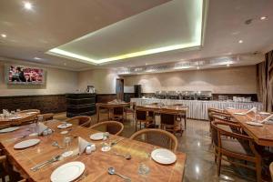 a large dining room with wooden tables and chairs at Palm Beach Hotel in Dubai