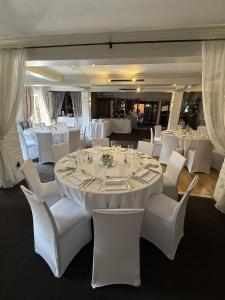 a dining room with white tables and white chairs at The Blue Anchor in Feering +7 photos