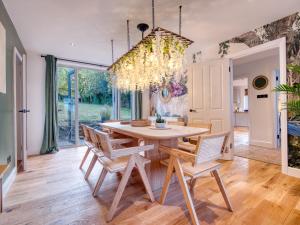 a dining room with a table and chairs at Oxford - hot tub, games room, parking, arcade in Oxford